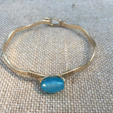 Worn Gold Tone Wavy Latch Bangle with Stone- Blue