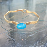 Worn Gold Tone Wavy Latch Bangle with Stone- Blue