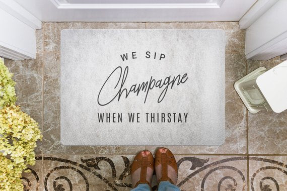 We Sip Champagne Welcome Mat-Stone/Black